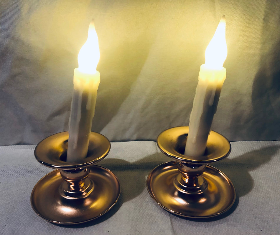 Pair of candlesticks and electric candles